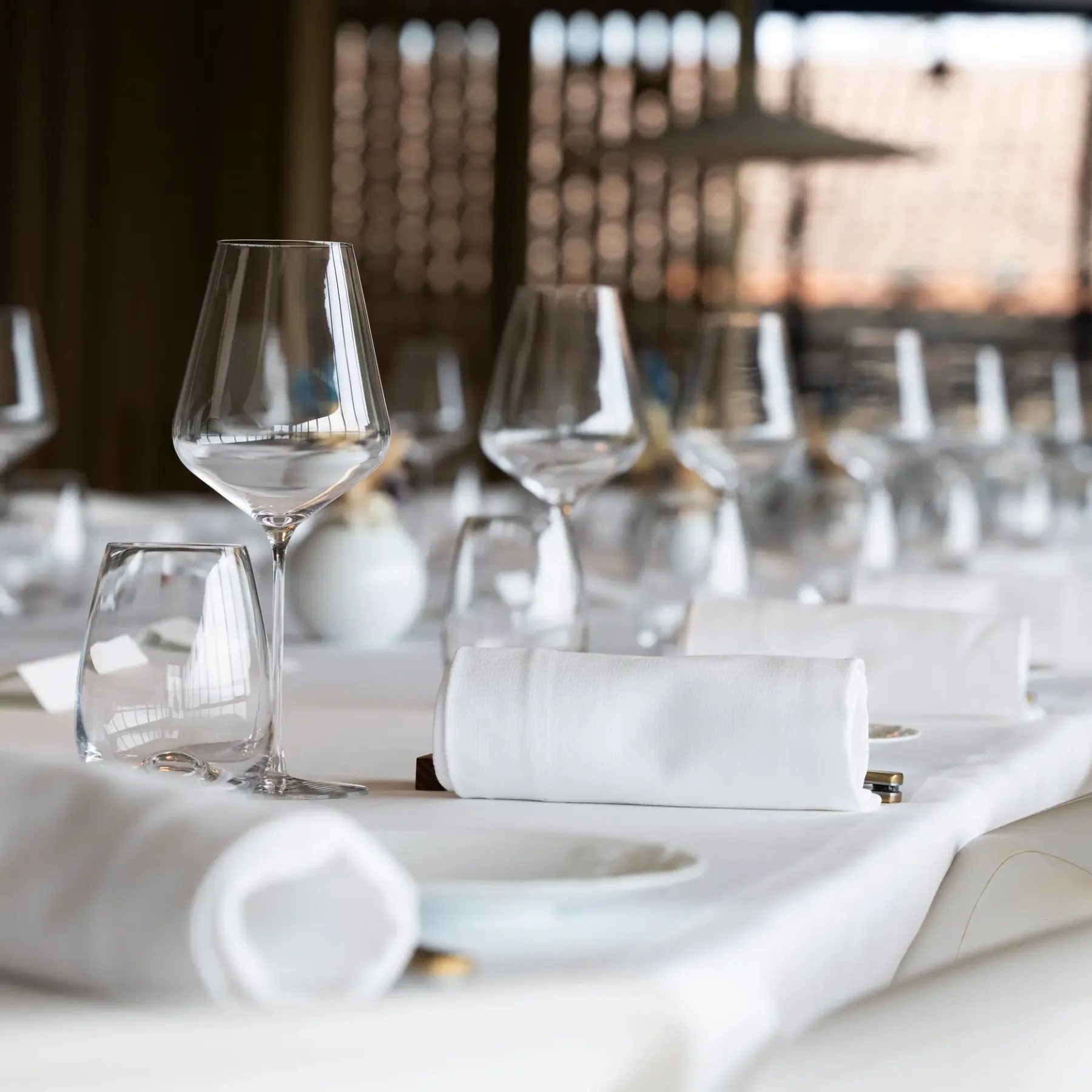 Table set with wine glasses, napkins, and plates, close-up view