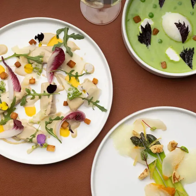 Three plates of gourmet dishes arranged on a table, with varied ingredients and artistic presentations.